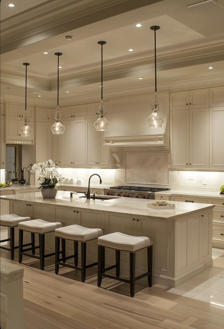 Bright luxury kitchen with marble island and warm pendant lighting
